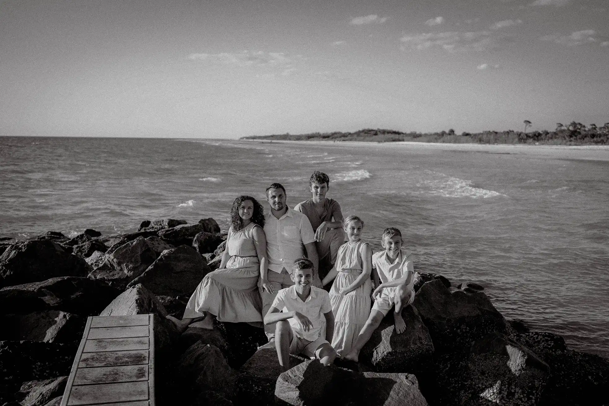 Photo of a family sitting on rocks